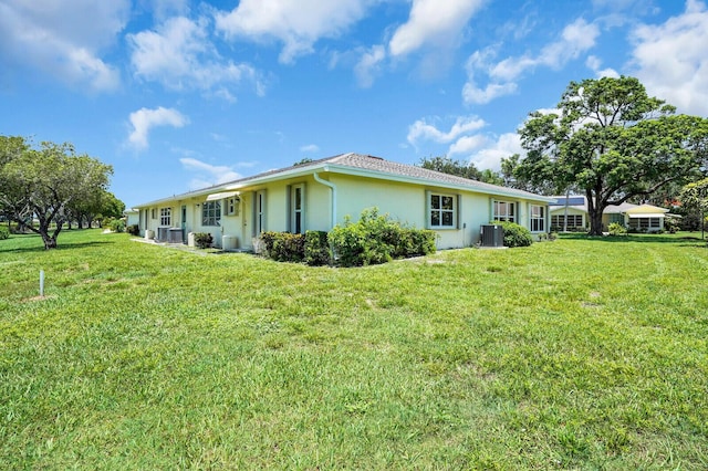 5229 Lakefront Blvd Unit A, Delray Beach, FL 33484 - back of property with stucco siding and a lawn