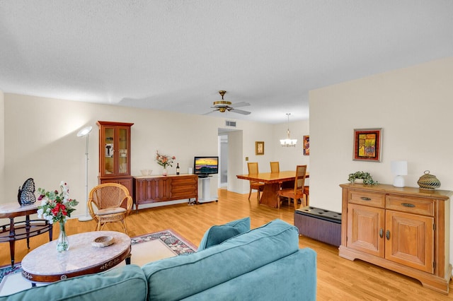 5229 Lakefront Blvd Unit A, Delray Beach, FL 33484 - living room with light wood-style floors, a ceiling fan, and a chandelier