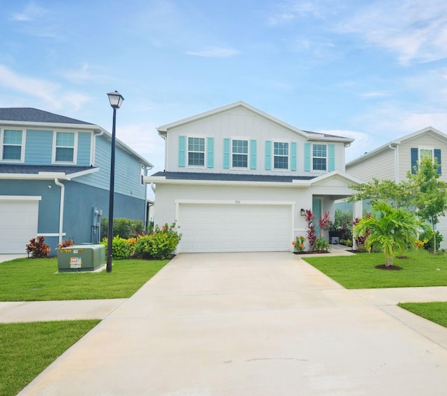9351 SW Serapis Way, Port Saint Lucie, FL 34987 - traditional home featuring a garage, a front lawn, driveway, stucco siding, and board and batten siding