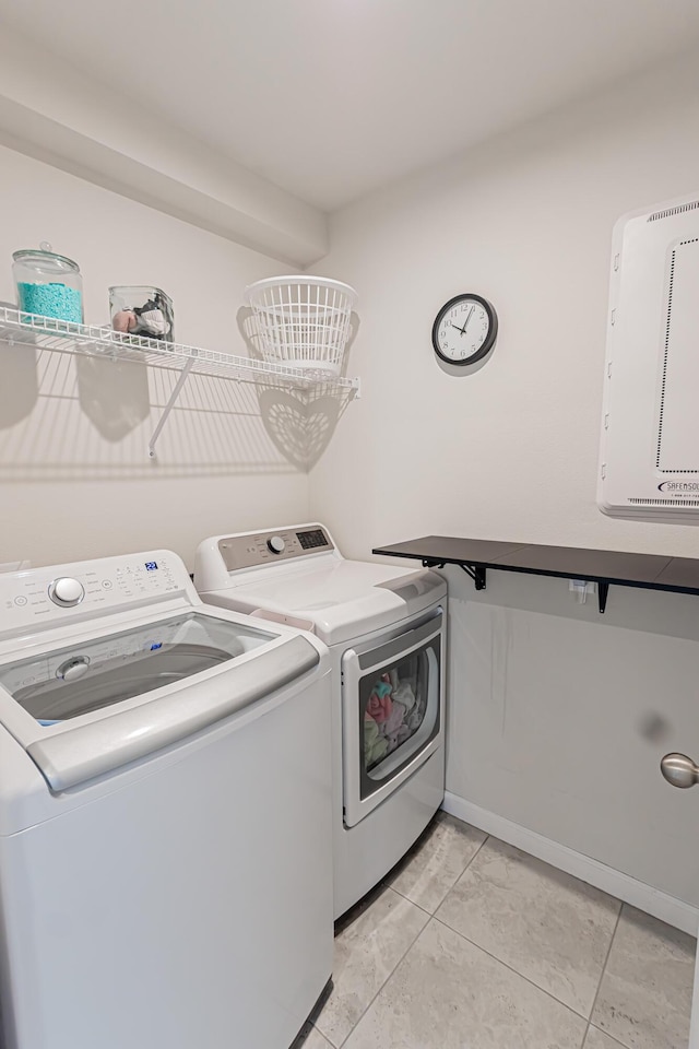 9351 SW Serapis Way, Port Saint Lucie, FL 34987 - washroom with washer and dryer, baseboards, and light tile patterned flooring