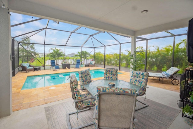 9351 SW Serapis Way, Port Saint Lucie, FL 34987 - outdoor pool featuring a patio area, outdoor dining area, and glass enclosure
