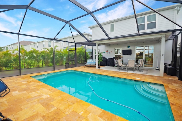 9351 SW Serapis Way, Port Saint Lucie, FL 34987 - outdoor pool featuring a patio, outdoor dining space, and glass enclosure
