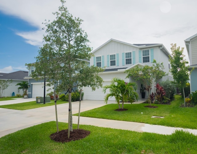 9351 SW Serapis Way, Port Saint Lucie, FL 34987 - view of front of home featuring concrete driveway, board and batten siding, a garage, and a front yard