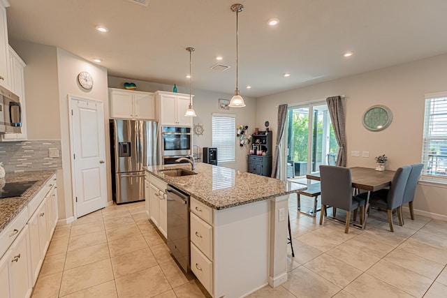 9351 SW Serapis Way, Port Saint Lucie, FL 34987 - kitchen with stainless steel appliances, a sink, plenty of natural light, recessed lighting, and backsplash