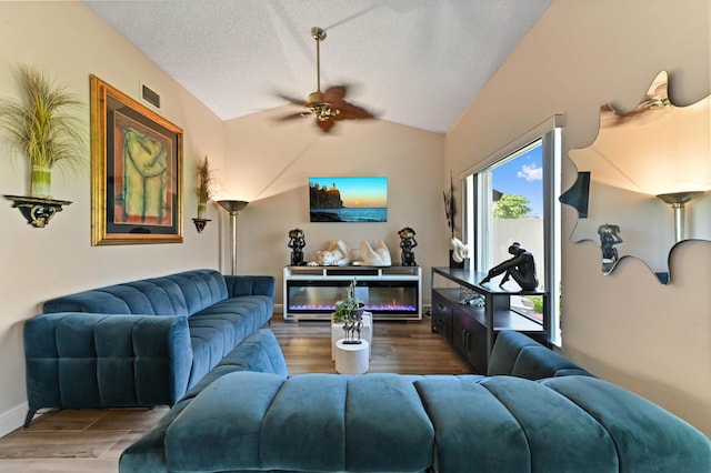 8178 Mooring Cir, Boynton Beach, FL 33472 - living room featuring a ceiling fan, wood finished floors, vaulted ceiling, a textured ceiling, and baseboards