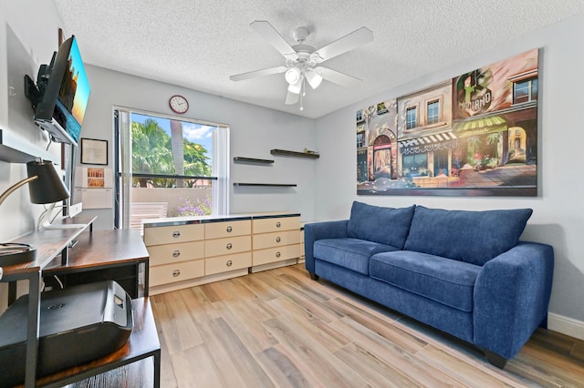 8178 Mooring Cir, Boynton Beach, FL 33472 - living area featuring ceiling fan, light wood-style floors, and a textured ceiling