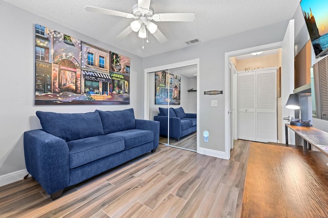 8178 Mooring Cir, Boynton Beach, FL 33472 - living area featuring wood finished floors, a ceiling fan, a textured ceiling, and baseboards