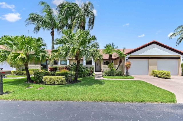 8178 Mooring Cir, Boynton Beach, FL 33472 - view of front of home with a tile roof, a front yard, concrete driveway, and an attached garage