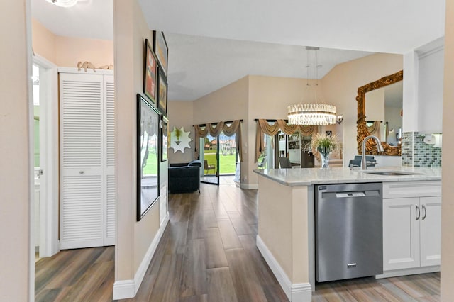 8178 Mooring Cir, Boynton Beach, FL 33472 - kitchen featuring dishwasher, a sink, wood finished floors, tasteful backsplash, and decorative light fixtures