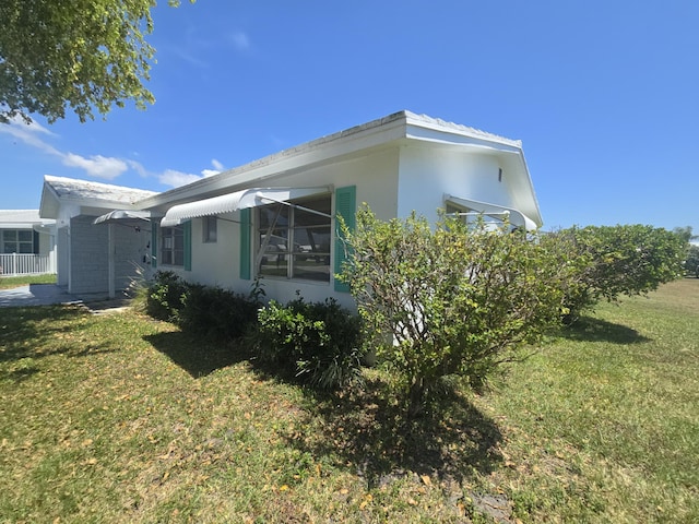 1003 SW 7th Ave, Boynton Beach, FL 33426 - view of property exterior with a lawn and stucco siding
