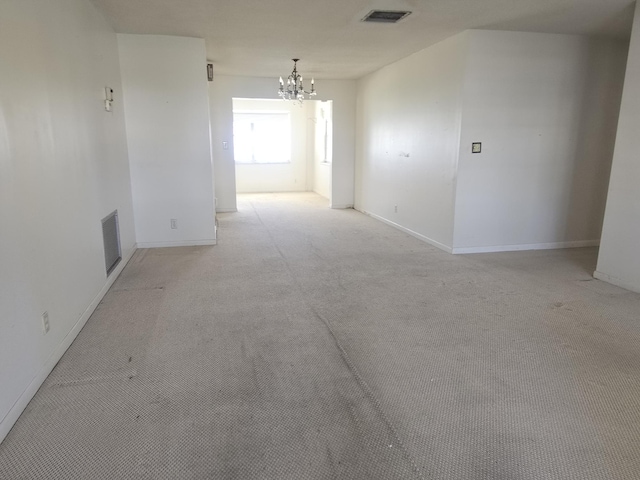 1003 SW 7th Ave, Boynton Beach, FL 33426 - spare room with a chandelier, light colored carpet, and baseboards