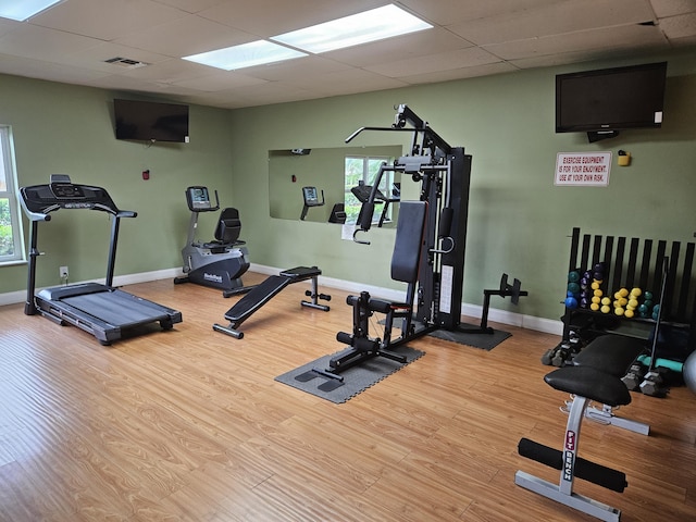 2941 Crrosley Dr W Unit E, West Palm Beach, FL 33415 - workout area featuring light wood-style flooring, a drop ceiling, and baseboards