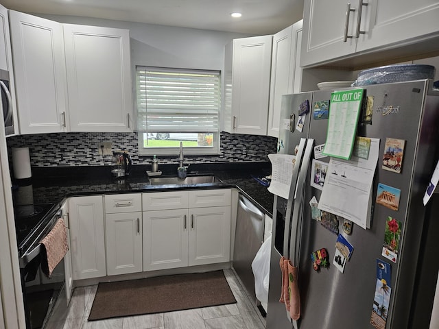 2941 Crrosley Dr W Unit E, West Palm Beach, FL 33415 - kitchen with appliances with stainless steel finishes, a sink, white cabinetry, backsplash, and recessed lighting