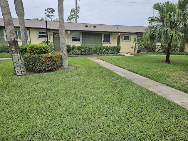 2941 Crrosley Dr W Unit E, West Palm Beach, FL 33415 - single story home featuring a front yard, stucco siding, and a shingled roof