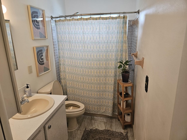 2941 Crrosley Dr W Unit E, West Palm Beach, FL 33415 - full bathroom with toilet, vanity, curtained shower, and wood finished floors