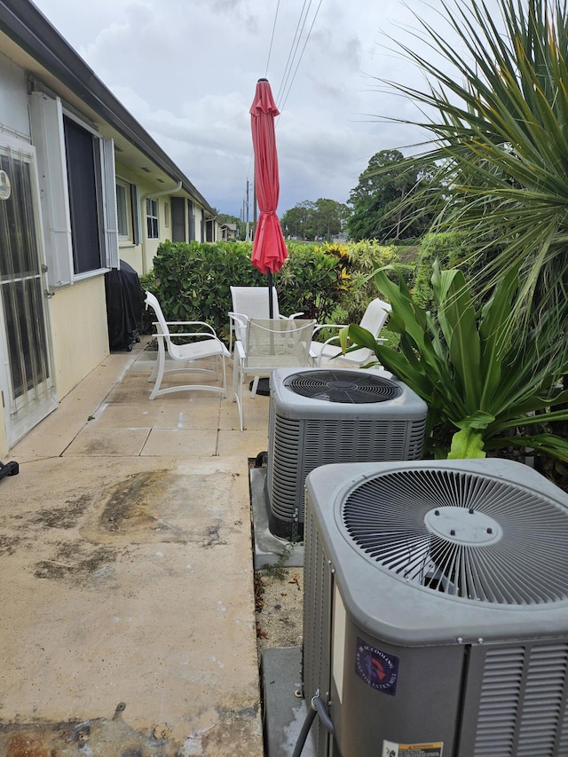 2941 Crrosley Dr W Unit E, West Palm Beach, FL 33415 - view of patio featuring central air condition unit and outdoor dining space