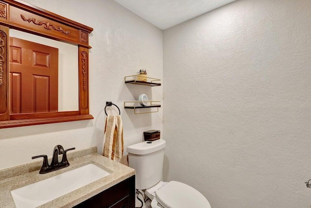 278 Monaco Way Unit F, Delray Beach, FL 33446 - half bath featuring a textured wall, vanity, and toilet