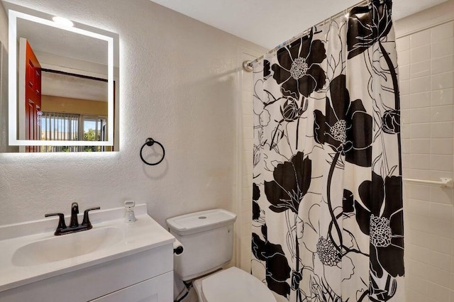 278 Monaco Way Unit F, Delray Beach, FL 33446 - full bathroom featuring a textured wall, vanity, toilet, and curtained shower