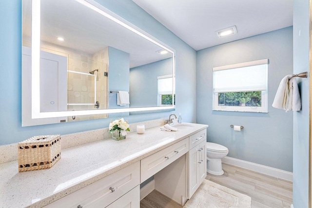 215 Cortez Rd, West Palm Beach, FL 33405 - bathroom with vanity, toilet, a tile shower, wood finished floors, and baseboards