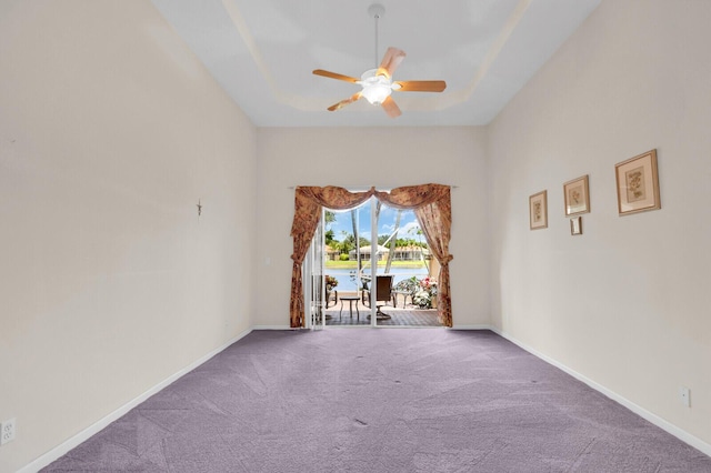 7144 Demedici Cir, Delray Beach, FL 33446 - carpeted empty room featuring a water view, ceiling fan, and a raised ceiling