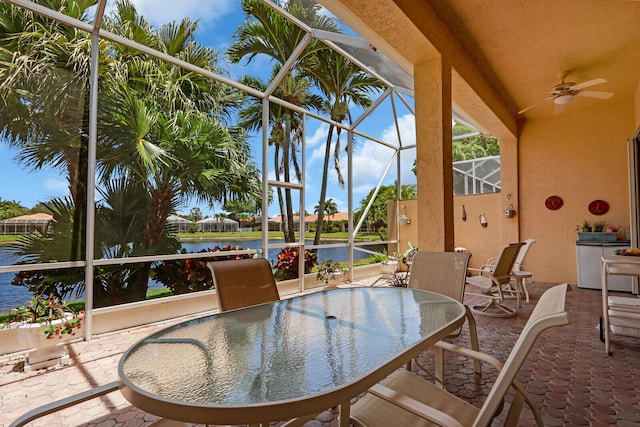 7144 Demedici Cir, Delray Beach, FL 33446 - view of patio / terrace featuring outdoor dining space, glass enclosure, ceiling fan, and a water view