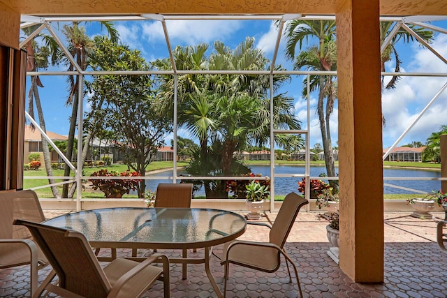 7144 Demedici Cir, Delray Beach, FL 33446 - view of patio featuring a water view, glass enclosure, and outdoor dining area