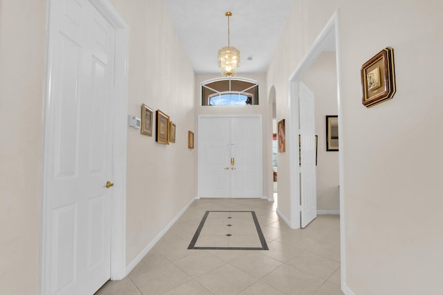 7144 Demedici Cir, Delray Beach, FL 33446 - foyer with light tile patterned floors, a chandelier, and arched walkways