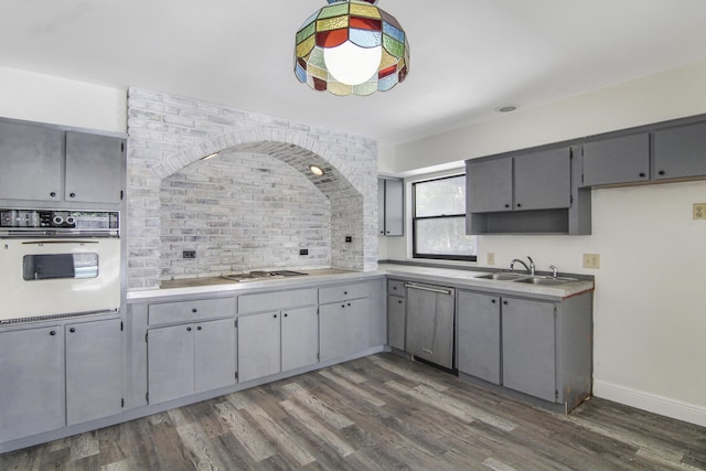5666 SE Matousek St, Stuart, FL 34997 - kitchen with white oven, gray cabinetry, stainless steel dishwasher, and a sink