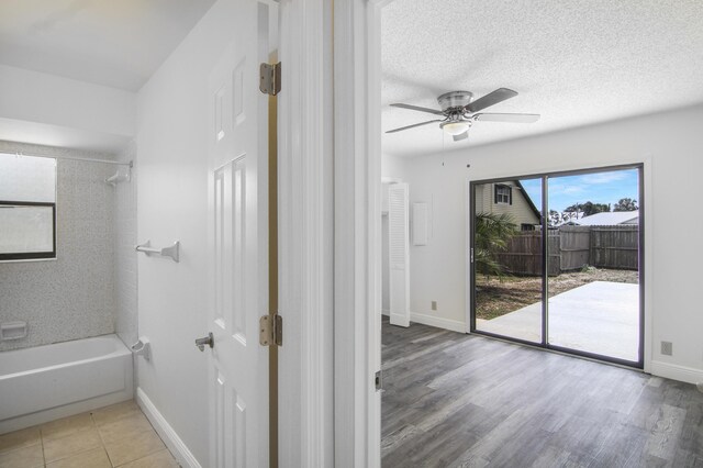 5666 SE Matousek St, Stuart, FL 34997 - full bath featuring bathing tub / shower combination, ceiling fan, baseboards, and wood finished floors