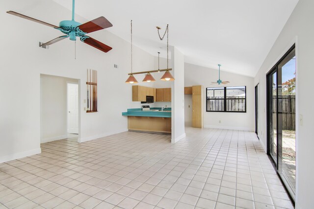 5666 SE Matousek St, Stuart, FL 34997 - unfurnished living room featuring a ceiling fan, high vaulted ceiling, and baseboards