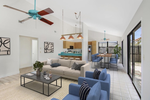 5666 SE Matousek St, Stuart, FL 34997 - living area with ceiling fan, light tile patterned floors, high vaulted ceiling, and baseboards