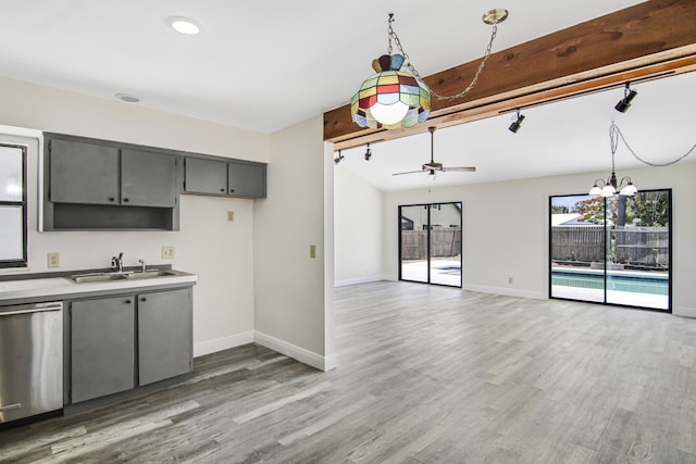 5666 SE Matousek St, Stuart, FL 34997 - kitchen with gray cabinets, baseboards, wood finished floors, and stainless steel dishwasher