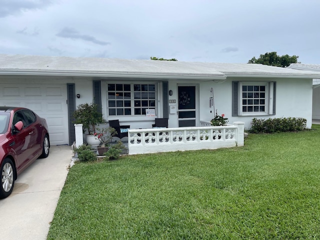 108 SW 18th St, Boynton Beach, FL 33426 - single story home with covered porch, an attached garage, a front yard, and stucco siding