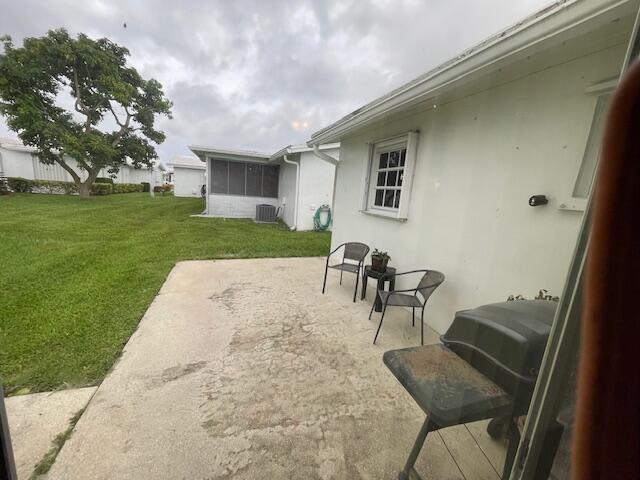 108 SW 18th St, Boynton Beach, FL 33426 - view of patio featuring central AC