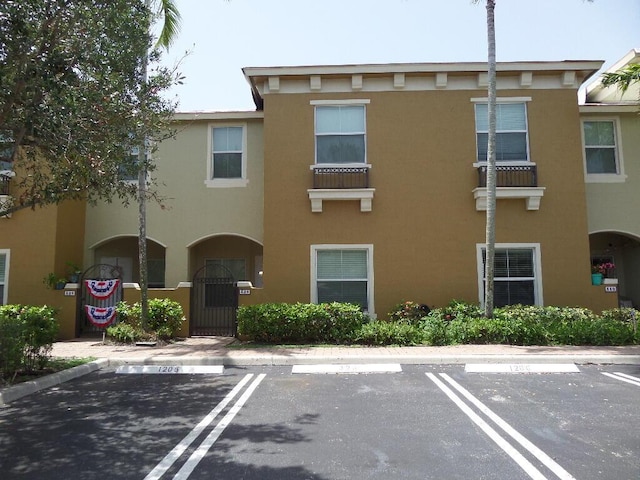 328 Lake Monterey Cir, Boynton Beach, FL 33426 - view of property featuring uncovered parking