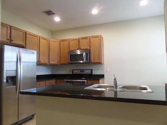 328 Lake Monterey Cir, Boynton Beach, FL 33426 - kitchen featuring appliances with stainless steel finishes, a sink, dark countertops, recessed lighting, and brown cabinetry