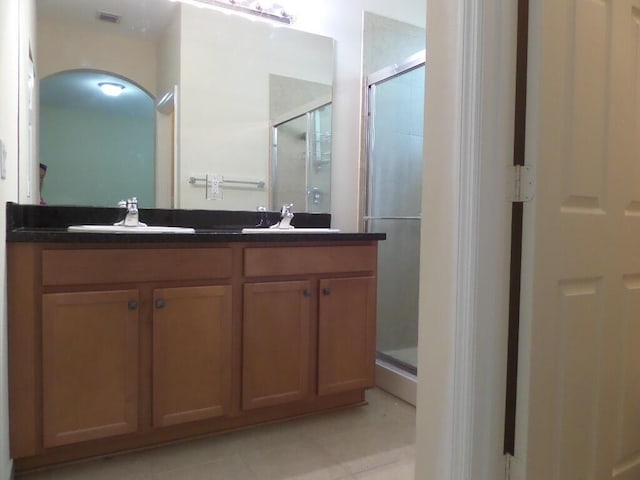 328 Lake Monterey Cir, Boynton Beach, FL 33426 - bathroom with a stall shower, double vanity, and tile patterned floors