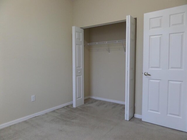 328 Lake Monterey Cir, Boynton Beach, FL 33426 - unfurnished bedroom featuring carpet floors, a closet, and baseboards