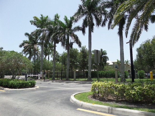 328 Lake Monterey Cir, Boynton Beach, FL 33426 - view of asphalt road featuring curbs and traffic signs