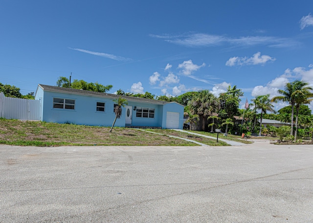 1715 12th Ave N, Lake Worth Beach, FL 33460 - view of front facade with an attached garage, stucco siding, and driveway