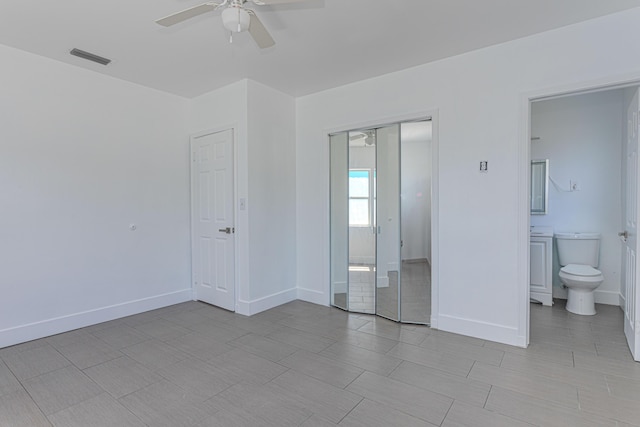 1715 12th Ave N, Lake Worth Beach, FL 33460 - unfurnished bedroom with a closet, ensuite bathroom, and a ceiling fan