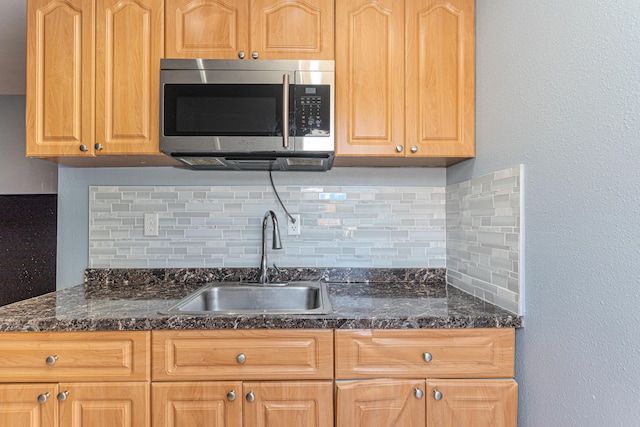 1715 12th Ave N, Lake Worth Beach, FL 33460 - kitchen featuring stainless steel microwave, decorative backsplash, and dark stone countertops