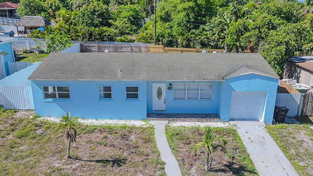 1715 12th Ave N, Lake Worth Beach, FL 33460 - view of front of property with stucco siding, a garage, roof with shingles, and driveway