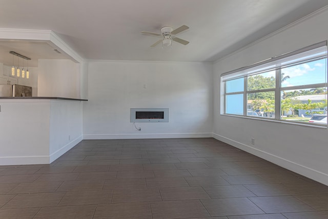 1715 12th Ave N, Lake Worth Beach, FL 33460 - unfurnished living room with ceiling fan, a fireplace, and crown molding