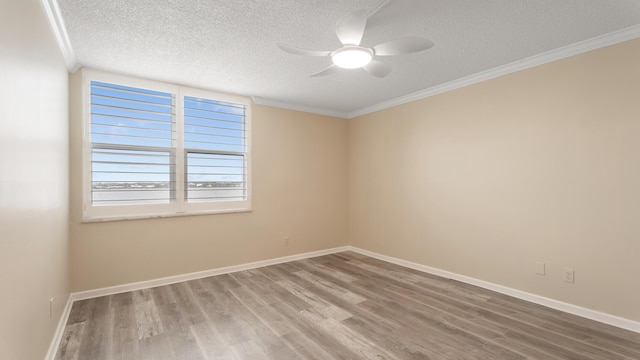1950 SW Palm City Rd Unit 8302, Stuart, FL 34994 - spare room featuring wood finished floors, a textured ceiling, ceiling fan, baseboards, and ornamental molding