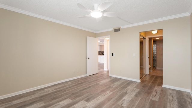 1950 SW Palm City Rd Unit 8302, Stuart, FL 34994 - unfurnished room with wood finished floors, crown molding, a ceiling fan, a textured ceiling, and baseboards
