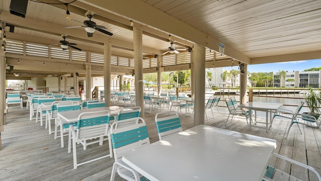 1950 SW Palm City Rd Unit 8302, Stuart, FL 34994 - wooden terrace featuring ceiling fan, outdoor dining space, and a water view
