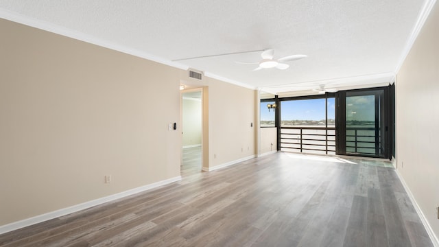 1950 SW Palm City Rd Unit 8302, Stuart, FL 34994 - unfurnished room featuring ceiling fan, a textured ceiling, ornamental molding, wood finished floors, and baseboards