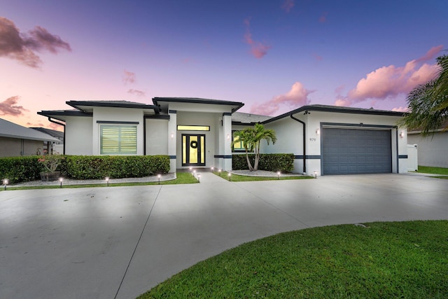 979 SW Mcdevitt Ave, Port Saint Lucie, FL 34953 - view of front of home with stucco siding, concrete driveway, and an attached garage