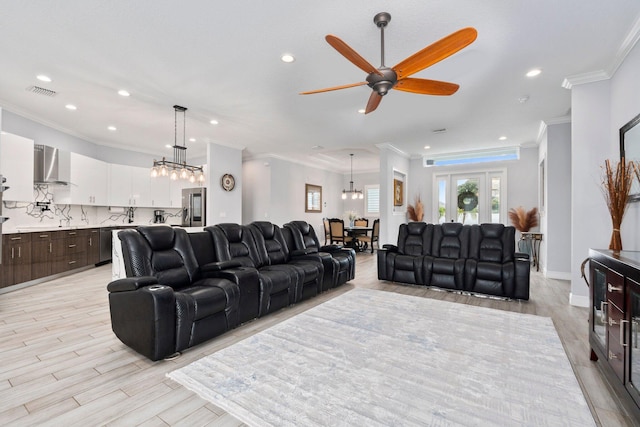 979 SW Mcdevitt Ave, Port Saint Lucie, FL 34953 - living room with recessed lighting, ornamental molding, ceiling fan, light wood finished floors, and a chandelier